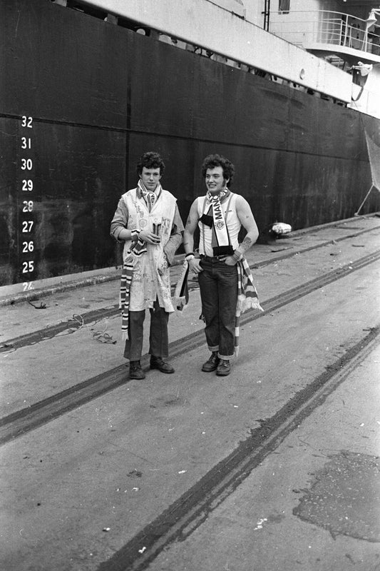Two Manchester United Fans in Front of A Ship (3) by Iain SP Reid - c. 1976