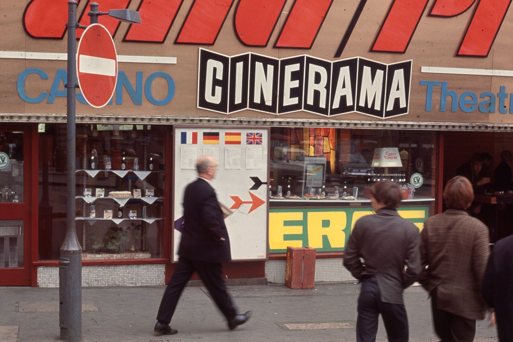 Man Striding By Cinerama by Bob Hyde. Taken in Soho, London, in the 1960s.