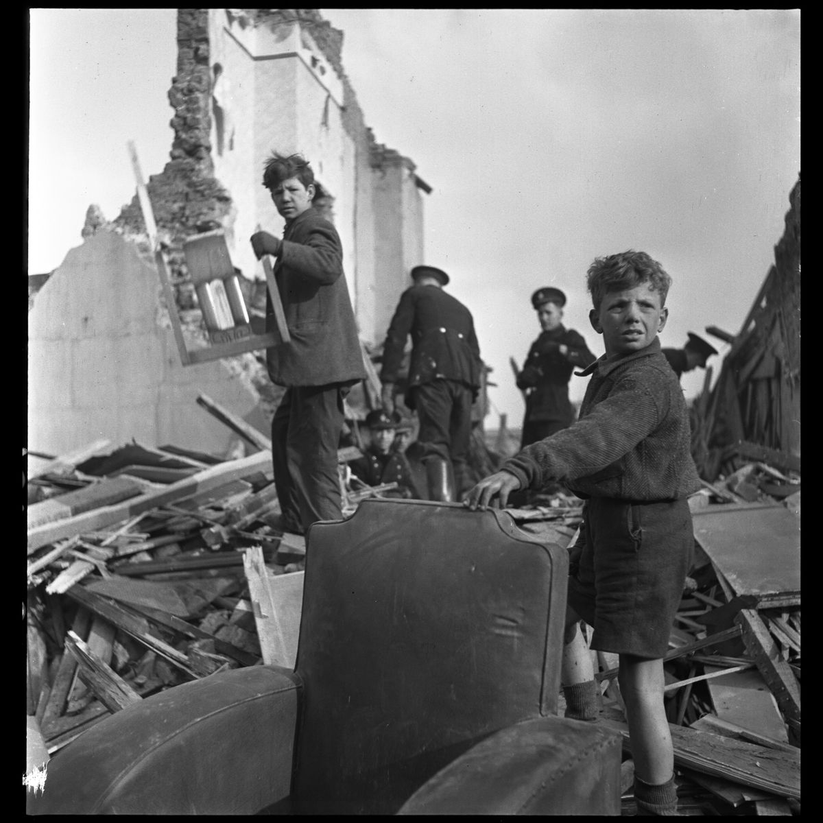 People and wreckage of buildings after a bombing raid of London during World War II in January 1945.