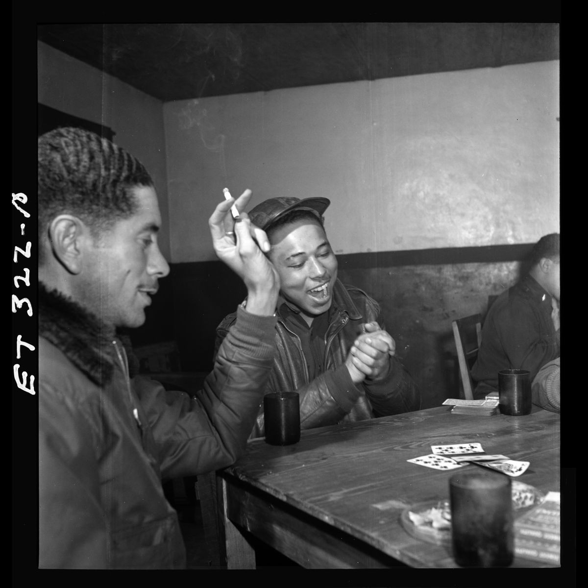 Tuskegee airmen playing cards in the officers' club in the evening by Toni Frissell - March 1945