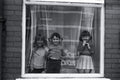 Three Children in A Window in Manchester (2) by Iain SP Reid - c. 1977