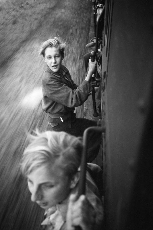 Boys cling on to a train as they celebrate The Netherlands' freedom from German Occupation (II) - by Menno Huizinga - 1945.