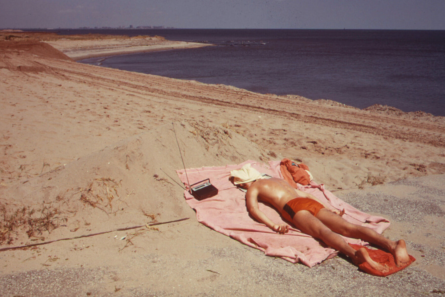 Lifeguard Takes a Sunbath at Great Kills Park on Staten Island by Arthur Tress - 1973