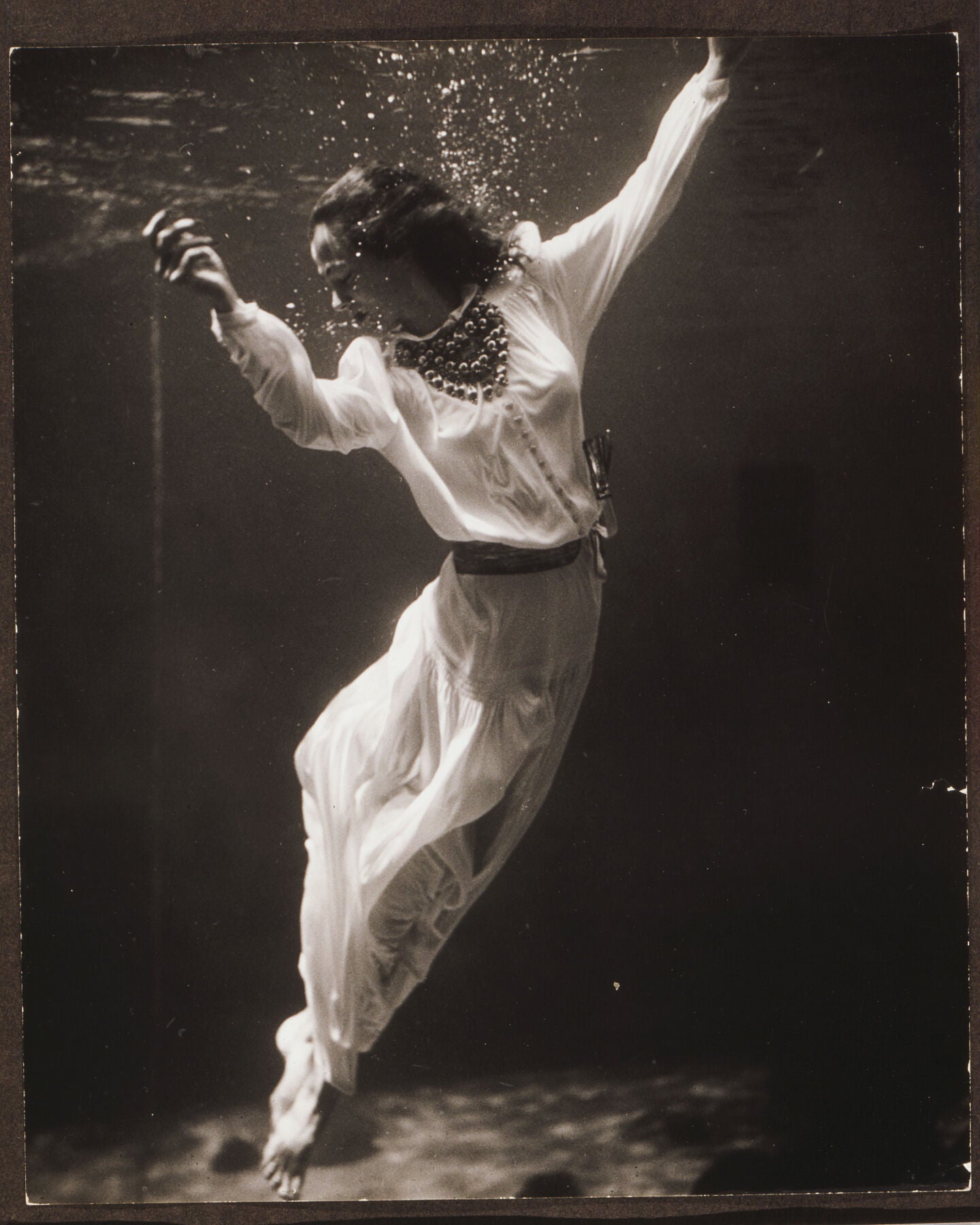 Fashion model underwater in a dolphin tank, Marineland, Florida by Toni Frissell, 1939