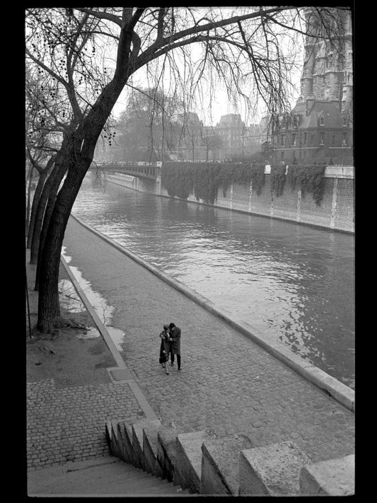 A couple walking along the Seine River in Paris by Toni Frissell - c.1955