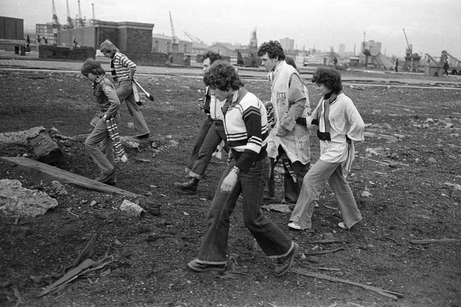 Football Fans Walking Across Wasteland in Manchester, England by Iain SP Reid - c. 1976