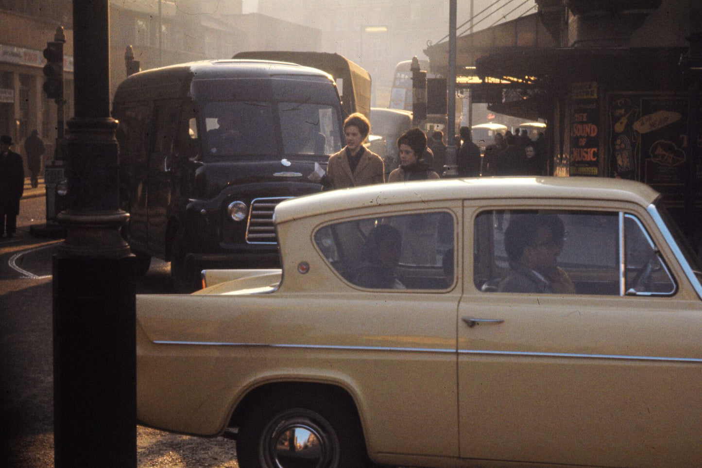 Cream Ford Anglia in London by Bob Hyde - 1960s