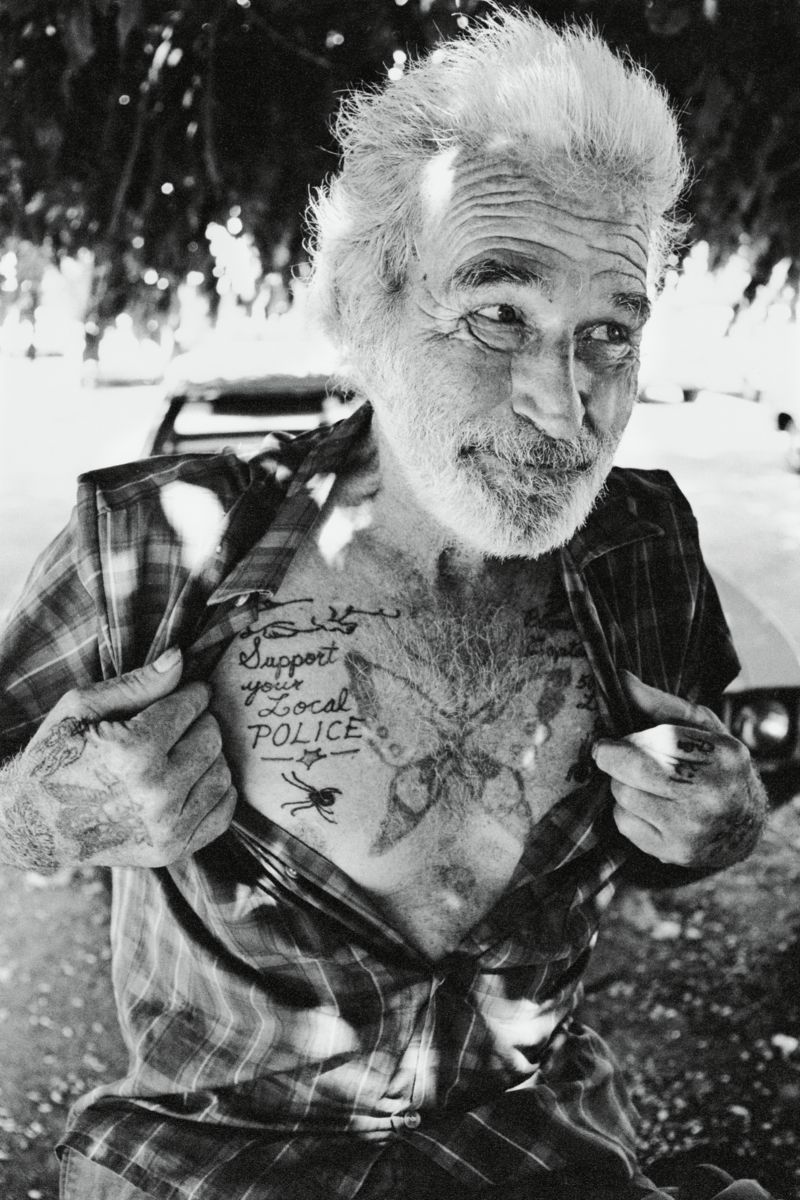 Man With Support Your Local Police Tattoo - Lummus Park, Miami by Michael Carlebach.