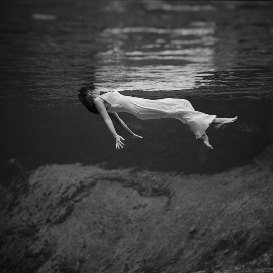 Underwater view of a woman, wearing a long gown, floating in water by Toni Frissell - 1947 100x100