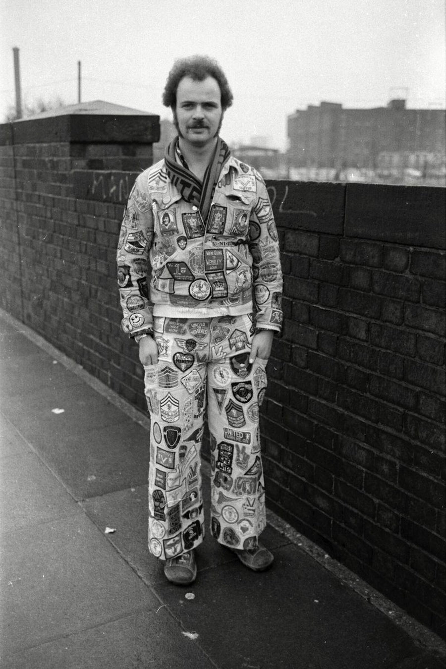 Manchester United Fan with Badges by Iain S. P. Reid, c. 1977. Copyright: Estate of Iain S.P. Reid. Not to be used for any purpose without permission