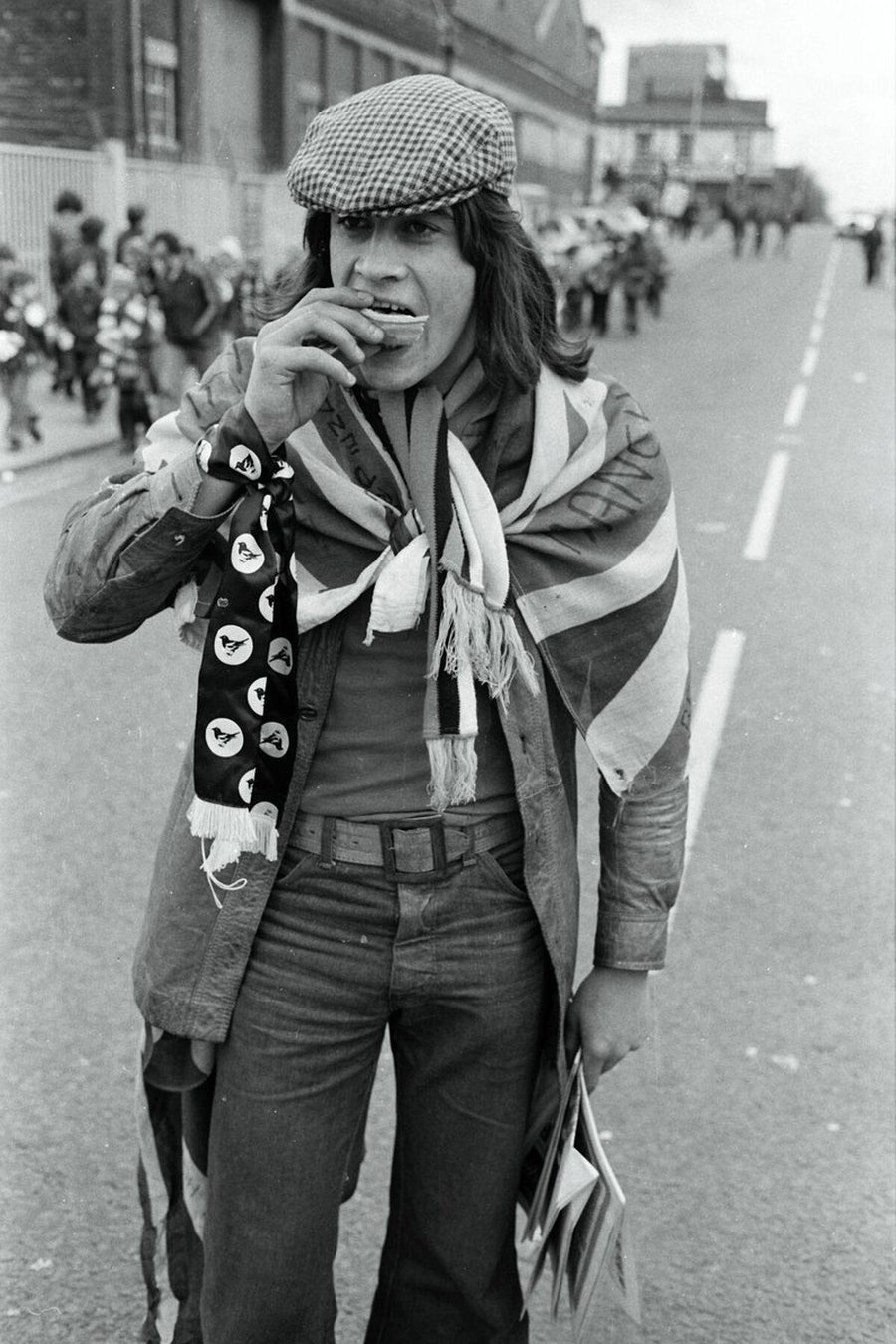 Football fan eating a pie in Manchester, England by Iain S.P. Reid - c. 1976