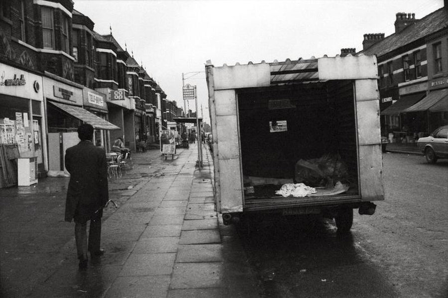 Refuse truck on a Manchester Street by Iain SP Reid - c. 1976.  The street is Alexandra Road. Photo view is looking north.