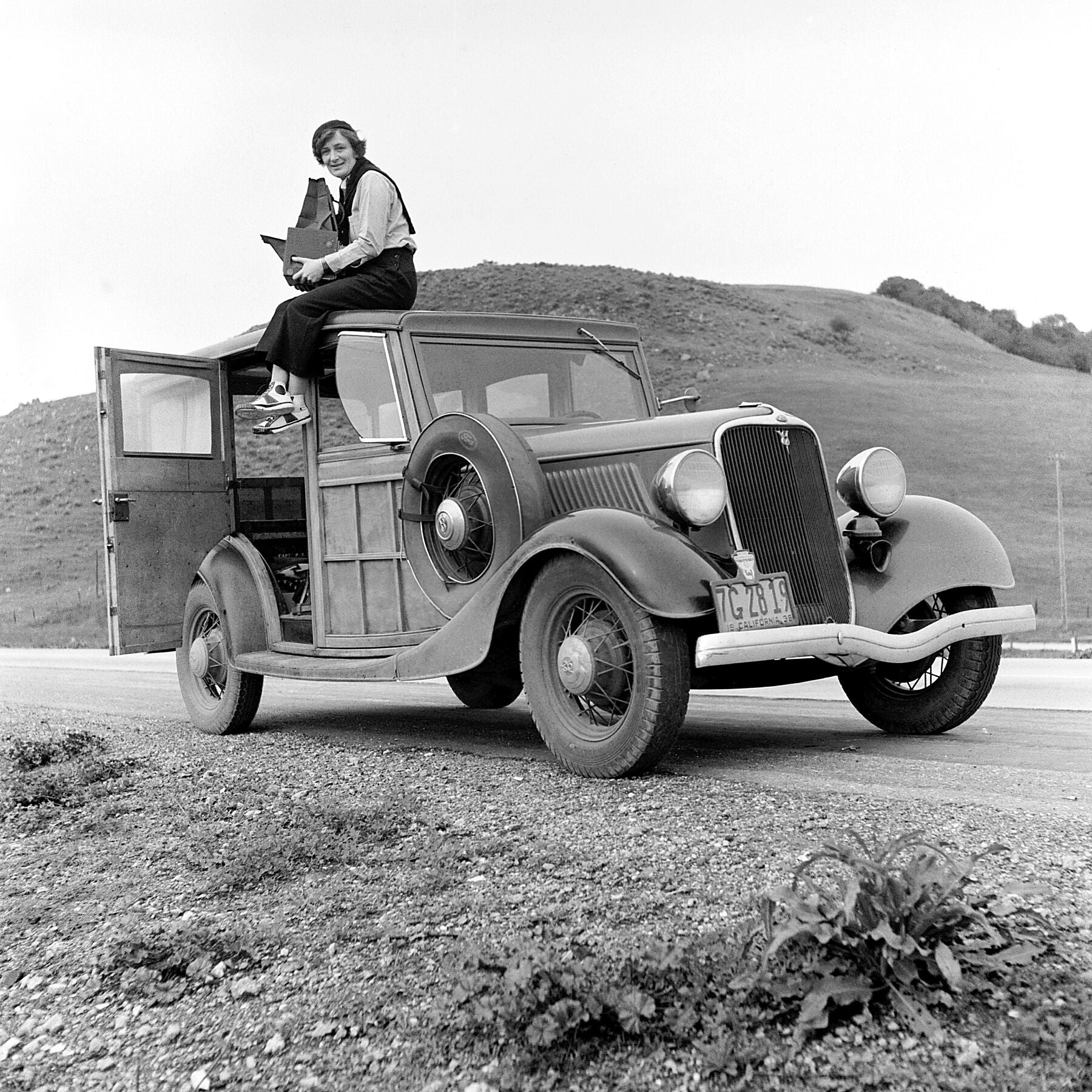 Dorothea Lange, Resettlement Administration photographer, in California. The car is a w-Ford Model V8 1936