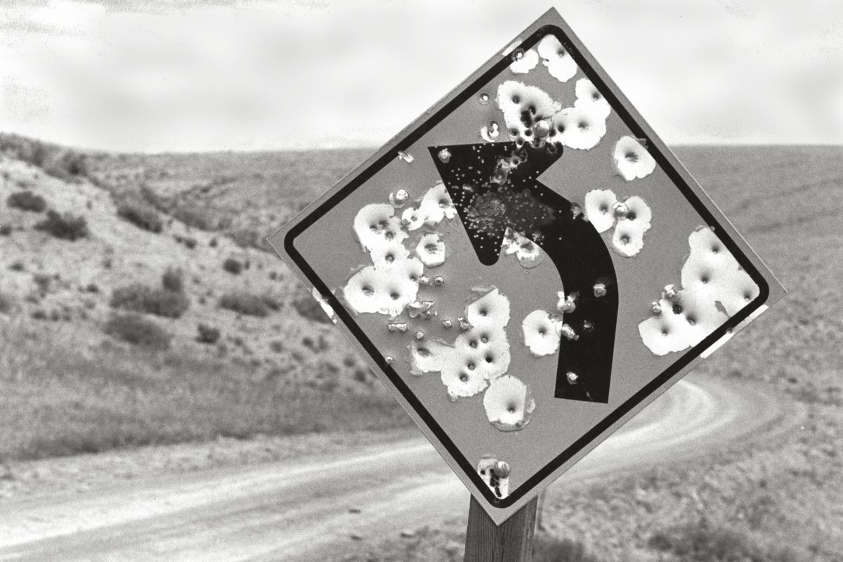 Sign with Bullet Holes, Wyoming by Michael Carlebach - 1992-06-29