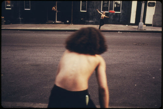Boys Playing Frisbee Across West 46th Street in Manhattan New York City by Danny Lyon - 1973