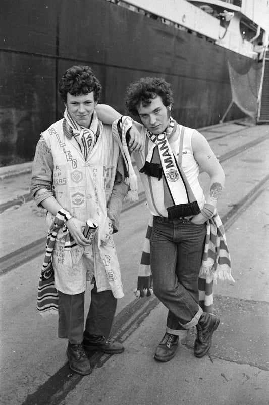 Two Manchester United Fans in Front of A Ship by Iain SP Reid - c. 1976